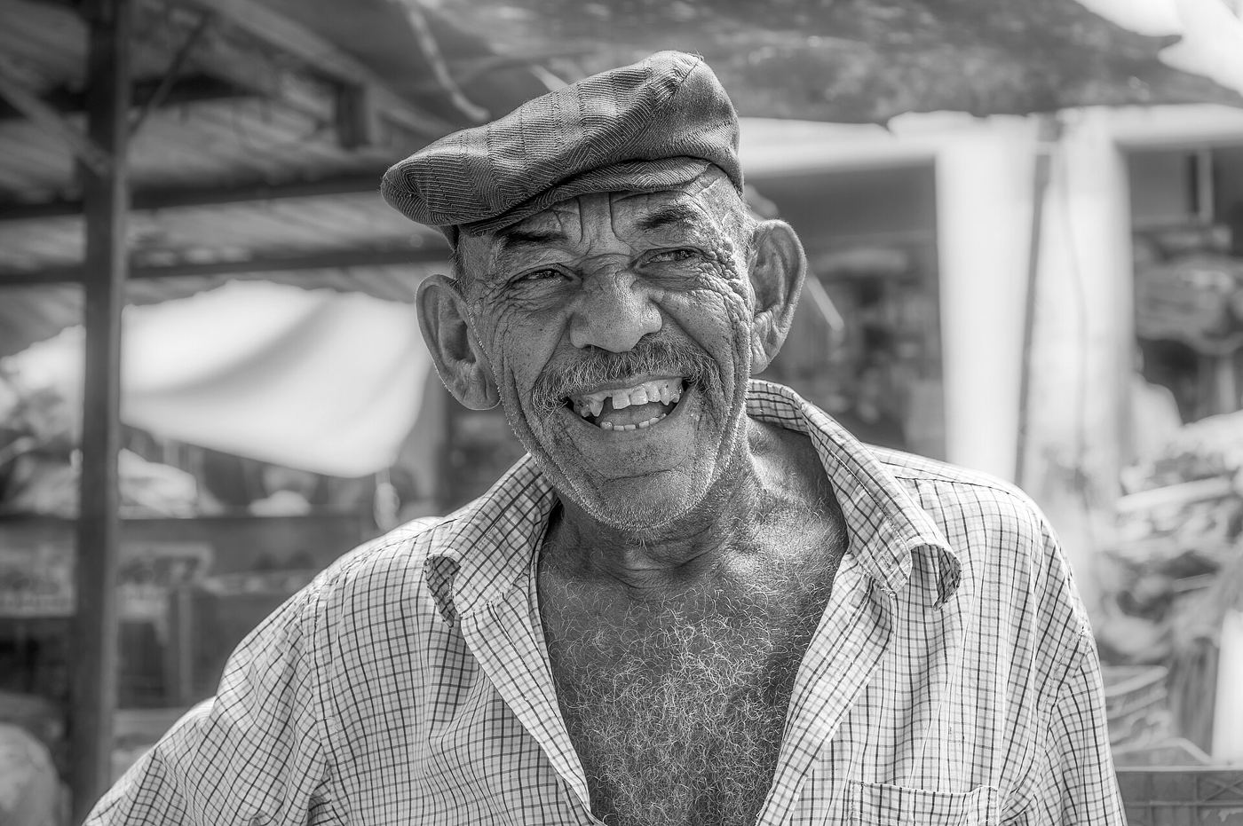 A bright portrait photograph of a person smiling at the camera